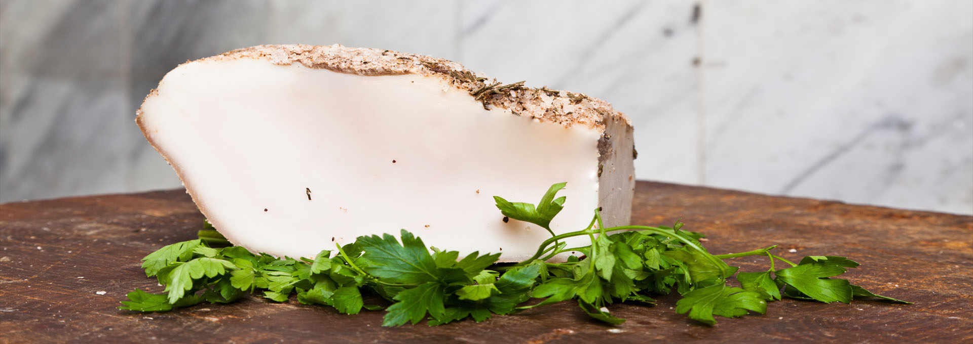 Snow-White Lardo di Colonnata Rests in Marble Cradles