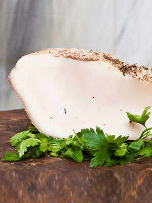 Snow-White Lardo di Colonnata Rests in Marble Cradles