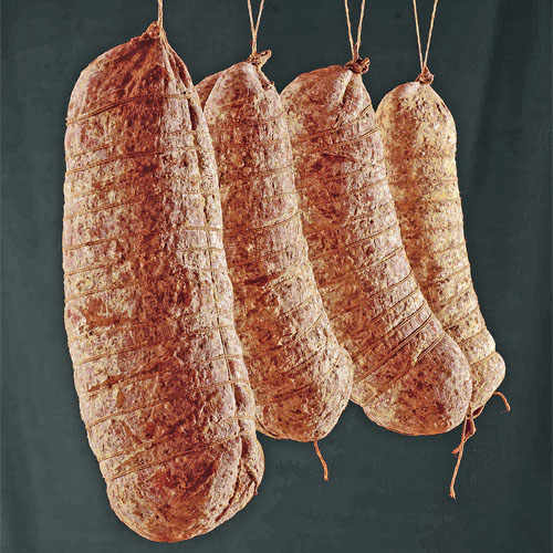 After reaching its final shape, sopressa is hung onto wooden beams to drip-dry and aged in a well-ventilated interior with regulated temperature and humidity.